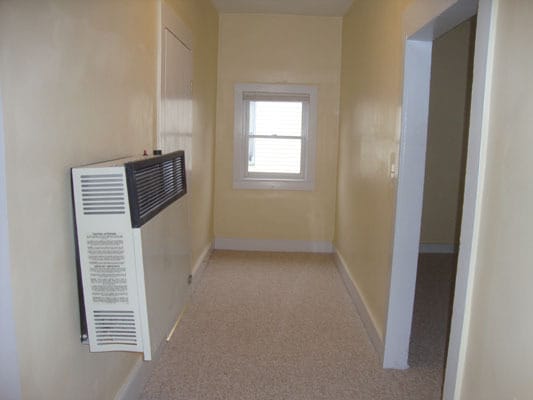 Hall. 2 bedrooms and gas heater on left. Living Room on right. - 130 N Shenango St