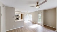 Located at 20 Mason Dr in Red Bank, Tennessee, this one-bedroom, one-bathroom residence offers a well-designed single-floor layout with a cohesive, modern aesthetic throughout. Light wood-style flooring spans the entire home, complementing the neutral warm-gray wall tones that create a bright, welcoming atmosphere.

The open-concept living and kitchen area serves as the heart of the home. The living space features vaulted ceilings with a ceiling fan and light fixture, large windows, and a glass door that opens directly onto a private balcony overlooking lush, mature trees — bringing in generous natural light and a serene outdoor connection. The kitchen is efficiently appointed with white shaker-style cabinetry, granite-look countertops, a subway tile backsplash, and a full suite of black appliances including a refrigerator, electric range, and over-the-range microwave. A breakfast bar provides additional counter space and casual dining.

The bedroom is a comfortable, well-proportioned retreat featuring its own ceiling fan, a large window with outdoor views, and access to a closet. The full bathroom includes a granite-topped vanity with white cabinetry, a tiled tub-shower combination, and a large mirror. A dedicated entrance and hallway complete the thoughtfully organized floor plan.