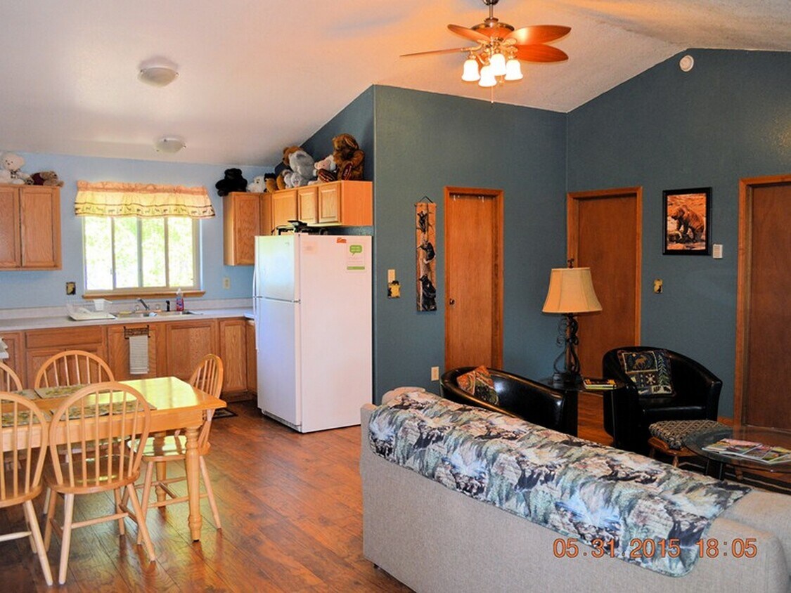 Another view of living/dining area and kitchen. - 24771 Amber Drive