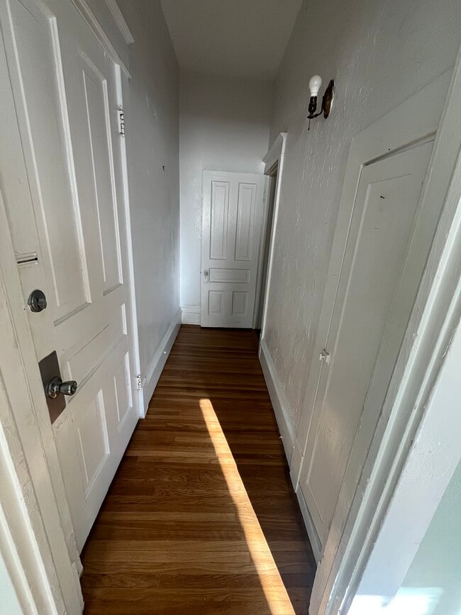 Hallway towards the bedroom form the front entry (door on the left). - 1521 South Center Street