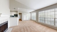 Located at 450 El Dorado Blvd in Houston, TX, this 2-bedroom, 1-bathroom single-floor home offers a well-organized layout with comfortable living spaces throughout. The open living room is bright and airy, featuring plush wall-to-wall carpeting, vaulted ceilings, large windows with blinds, and a set of French doors that invite natural light and outdoor views. The galley-style kitchen is a standout, showcasing white cabinetry with modern hardware, granite countertops, a tiled backsplash in cool blue-gray tones, hardwood flooring, and stainless steel appliances including a refrigerator, range, and dishwasher. A dedicated laundry area with overhead cabinetry adds everyday convenience. The primary bedroom offers comfortable proportions, soft carpeting, a ceiling fan, a sliding-door closet, and direct access to the bathroom. The second bedroom is bright with a window and neutral carpeting. The bathroom features a full tub-shower combination with clean white tile surround and hardwood flooring. Two closets provide ample storage, including a spacious walk-in with wire shelving. The home's neutral palette and functional layout make it a practical and inviting living space in the Houston area.