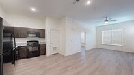This two-bedroom, two-bathroom apartment in Louisville, Kentucky offers a well-organized single-floor layout with a clean, modern aesthetic throughout. Light wood-style flooring flows consistently across the main living areas and bedrooms, complementing the crisp white walls and creating a bright, cohesive atmosphere.

The open kitchen is a functional highlight, featuring dark espresso cabinetry with brushed nickel hardware, granite-look countertops, a full suite of black appliances including a range, microwave, dishwasher, and refrigerator, and recessed lighting overhead. The kitchen transitions naturally into the open living area, which benefits from natural light through blinds-fitted windows and a ceiling fan above.

Both bedrooms are well-proportioned, with the primary bedroom offering generous space, multiple windows that invite natural light, and a ceiling fan. The second bedroom is equally bright, featuring a large window with blinds. Each bedroom is served by dedicated closet space.

The two bathrooms are finished consistently with tile flooring, dark vanity cabinetry, granite-look countertops, and full tub-shower combinations with clean white surrounds. A dedicated laundry area adds everyday convenience. The unit presents a move-in ready, contemporary living environment.