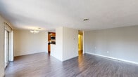 Located at 45 Kings Way in Waltham, MA, this 2-bedroom, 1-bathroom home offers a well-organized layout across a single floor. The open-concept living and dining area is anchored by smooth hardwood-style flooring and neutral-toned walls, creating a bright and airy atmosphere. A sliding glass door in the dining area fills the space with natural light and provides views of the surrounding neighborhood. The kitchen is thoughtfully appointed with warm oak cabinetry, dark granite countertops, and stainless steel appliances including a refrigerator, dishwasher, and microwave, offering both style and functionality. The bathroom features a wide vanity with a large mirror and a full shower enclosure. Both bedrooms are carpeted for comfort; the primary bedroom is generously sized and features dual closets, while the second bedroom benefits from natural light through double windows. A carpeted staircase with clean white railings connects to the upper level. Throughout the home, textured ceilings, crisp white trim, and consistent flooring create a cohesive and move-in-ready aesthetic well-suited for comfortable everyday living in Waltham.