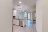 This 540 square foot apartment in Dallas, TX offers a thoughtful layout maximizing space and functionality. The heart of the home is a sleek, modern kitchen equipped with stainless steel appliances, including a full-size refrigerator, electric range, and over-the-range microwave. White shaker-style cabinets provide ample storage and contrast beautifully with the light-colored countertops.

The 110 square foot bedroom features plush carpeting and a large window with horizontal blinds, allowing natural light to filter in. A spacious closet offers additional storage space. The bathroom boasts a contemporary design with a single vanity, large mirror, and a combination tub/shower. Light wood-look flooring in the bathroom and kitchen adds warmth and durability to these high-traffic areas.

Throughout the apartment, recessed lighting and neutral wall colors create a bright, airy atmosphere. The efficient floor plan includes a dedicated closet space, enhancing the overall storage capacity of this compact yet comfortable living space. This well-designed apartment strikes a balance between style and practicality, perfect for modern urban living.