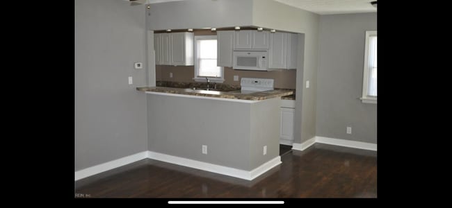 Older photo of living room/kitchen due to current tenants privacy - 8803 Chesapeake Blvd