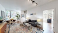 This thoughtfully designed 2-bedroom, 3-bathroom residence offers a comfortable and functional single-floor layout with a bright, modern aesthetic. The open-concept living area seamlessly connects the kitchen, dining, and living spaces, all finished with light-toned hardwood flooring and crisp white walls. Large windows flood the living room with natural light and offer views of lush greenery outside, creating an inviting, airy atmosphere complemented by track lighting overhead.

The kitchen is well-equipped with rich dark cabinetry, a white quartz peninsula with bar seating, white subway tile backsplash, and a full suite of stainless steel appliances. It opens directly to the living and dining area, making it ideal for entertaining.

The primary bedroom is a generously sized retreat featuring a walk-in closet, hardwood flooring, and soft ambient lighting. The second bedroom benefits from multiple windows on two walls, offering abundant natural light and garden views, along with a ceiling fan for added comfort.

The bathrooms are cleanly finished with dark wood vanities, white quartz countertops, and tub-shower combinations. Two dedicated closets provide ample storage throughout the residence. The unit's cohesive design, quality finishes, and well-proportioned rooms make it a highly functional and attractive living space.