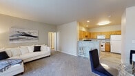 Located at 9123 Cleveland St in Merrillville, Indiana, this 2-bedroom, 2-bathroom residence offers a thoughtfully designed single-floor layout that balances comfort and functionality. The open-concept living and dining area features plush carpeting, neutral gray walls, and a sliding glass door dressed with vertical blinds that invites natural light into the space. The kitchen is a standout feature, equipped with warm honey-toned wood cabinetry, granite-style countertops, a breakfast bar with seating, hardwood-style flooring, and a full suite of white appliances including a gas range, dishwasher, and refrigerator. Both bedrooms are generously sized with soft carpeting, large windows that bring in ample natural light, and dedicated closet space. The primary bedroom benefits from a walk-in closet, adding practical storage. The second bedroom also features its own closet and large window. Each bathroom is well-appointed with granite-topped vanities, warm wood cabinetry, a tub-shower combination, and hardwood-style flooring. Throughout the residence, the consistent use of neutral tones and quality finishes creates a clean, cohesive, and welcoming atmosphere.