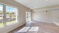 Located at 86 Creek Road in Poughkeepsie, NY, this well-appointed one-bedroom, one-bathroom residence offers a thoughtfully designed single-floor layout with modern finishes throughout. Light-toned hardwood flooring flows seamlessly across all living areas, complementing the warm neutral palette of the walls and trim.

The open-concept kitchen is a standout feature, showcasing sleek white shaker cabinetry, stainless steel appliances including a refrigerator, range, microwave, and dishwasher, and striking quartz countertops with subtle veining. Pendant lighting above the kitchen peninsula adds a refined touch, while recessed lighting ensures the space is bright and functional.

The living room is generously proportioned, bathed in natural light from large windows and a sliding glass door that opens to an outdoor area, creating an airy, open feel. The bedroom is a comfortable retreat, featuring its own large window with views of the surrounding greenery and two closets for ample storage.

The full bathroom is cleanly finished with large-format tile flooring, a vanity with storage, a full tub-shower combination, and recessed lighting. Throughout the residence, clean lines, neutral tones, and quality materials combine to create a cohesive, contemporary living environment.