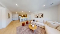 Located at 625 N Maple Ave, Unit 305 in Ho-Ho-Kus, NJ, this well-appointed 2-bedroom, 2-bathroom residence offers a thoughtfully designed single-floor layout with modern finishes throughout. The open-concept living and kitchen area serves as the heart of the home, featuring light hardwood flooring that flows seamlessly across the space. The kitchen is equipped with warm wood cabinetry, stainless steel appliances including a gas range, microwave, dishwasher, and refrigerator, complemented by crisp white countertops and an L-shaped peninsula with pendant lighting above. The living area is bright and inviting, with large windows allowing natural light to fill the room. The spacious primary bedroom provides a tranquil retreat with access to an en-suite bathroom and generous closet space featuring built-in shelving and dual hanging rods. The second bedroom is well-sized with a large window offering outdoor views. Both bathrooms are finished with light tile, wood-toned vanities, white countertops, and matte black hardware accents. Additional features include a laundry area, multiple closets for storage, and clean hallways with minimalist detailing. The overall ambiance is bright, contemporary, and move-in ready.