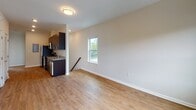 Located at 4909 Hamilton Ave in Baltimore, MD, this single-floor residence offers a thoughtfully designed layout with a clean, modern aesthetic. Warm hardwood-style flooring runs consistently throughout the living areas and bedrooms, lending a cohesive and inviting feel to the entire space.

The open-concept living and dining area is bathed in natural light from well-placed windows that frame views of the surrounding neighborhood greenery. The kitchen is a standout feature, equipped with rich dark-espresso cabinetry, granite countertops, a stainless steel sink, and a full suite of stainless steel appliances including a refrigerator, range, and over-the-range microwave — all complemented by durable hardwood-style flooring.

The bedrooms are generously proportioned, each featuring neutral-toned walls, natural light from large windows, and ample space for furnishings. The bathrooms are finished with light ceramic tile flooring and dark vanity cabinetry. One full bathroom includes a soaking tub and shower combination with classic white subway tile surround, while a second bathroom provides a clean, functional half-bath configuration with a modern vanity and mirror.

Throughout, the space maintains a bright, neutral palette with white trim and soft wall tones, creating a versatile and welcoming environment.