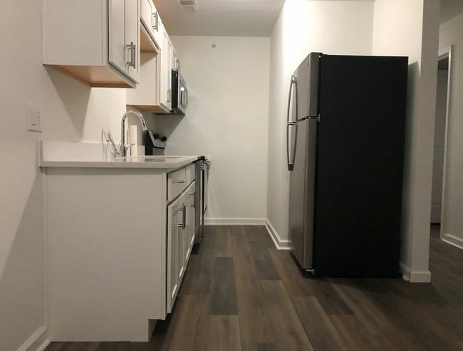 Renovated galley kitchen with new appliances. - 261 Simpson Ave