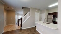 Located at 8172 W Eastman Pl in Lakewood, Colorado, this two-story home offers a well-designed layout with a range of functional features throughout. The main level showcases rich hardwood-style flooring that flows through the living and dining areas. The living room is a welcoming focal point, centered around a classic fireplace with a white-painted mantel and flanked by windows that invite abundant natural light. The kitchen is well-appointed with dark espresso cabinetry, light quartz-style countertops, a white subway tile backsplash, and stainless steel appliances including a range, over-the-range microwave. A kitchen island with a built-in sink adds additional workspace and storage. A convenient half bathroom is also found on the main level. The staircase, accented with dark wood balusters and white railings, leads to the upper floor, where carpeted bedrooms provide a comfortable retreat. Each bedroom features ceiling fans, ample natural light from multiple windows, and access to closet space. The bathrooms are finished with dark wood vanities, light countertops, and a tub-shower combo with tiled surrounds. This home combines practical design with comfortable living in a well-established Lakewood neighborhood.