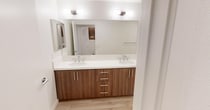 This contemporary single-story residence in Murrieta, CA, offers 1750 square feet of thoughtfully designed living space. The home boasts four bedrooms, including a generous 260 sq ft primary suite, and two full bathrooms. The modern kitchen is a highlight, featuring sleek wood cabinetry, stainless steel appliances, and ample counter space with a central island. Throughout the home, light wood flooring creates a warm, inviting atmosphere, complemented by recessed lighting and large windows that flood the rooms with natural light. The bedrooms are spacious and well-appointed, with the same attention to detail evident in the bathrooms, which showcase modern fixtures and finishes. A standout feature is the curved balcony, offering panoramic views of the surrounding landscape and providing an ideal outdoor space for relaxation or entertainment. The property's layout includes a combined kitchen and living area, three hallways for easy navigation, and a closet for additional storage. With its blend of style, comfort, and functionality, this home presents an attractive option for those seeking a modern living experience in a desirable location.