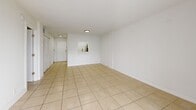 Located in Sunrise, FL, this well-appointed one-bedroom, one-bathroom unit offers a bright and efficiently designed single-floor layout. Light-toned ceramic tile flooring runs throughout the entire space, contributing to a clean, cohesive aesthetic. The combined living and dining area is generously proportioned, filled with natural light from a large sliding glass door that opens directly onto a private balcony with outdoor views of surrounding greenery. The kitchen features white cabinetry with modern hardware, a stainless steel sink with a pull-down faucet, white countertops, and a dishwasher, connected to the main living area via a pass-through window. The bedroom is a well-sized, private retreat with a dedicated window that invites natural light, and is served by a hallway that leads to the bathroom. The bathroom is a standout feature, finished with elegant marble-style tile on both the floors and walls, complemented by a soaking tub and shower combination. Multiple closets are distributed throughout the unit, providing ample storage. The entrance opens into a welcoming hallway that transitions smoothly into the main living space, creating a logical and functional flow throughout.