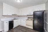 Located at 1515 S Mebane St in Burlington, NC, this single-story, one-bedroom, one-bathroom unit offers a practical and well-designed layout across a compact but functional floor plan. The living room welcomes you with wood-look vinyl plank flooring in a warm gray tone, neutral two-tone walls with white chair rail accents, and a large sliding glass door fitted with vertical blinds that flood the space with natural light. The kitchen is efficiently arranged in an L-shape configuration, featuring white cabinetry extending to the upper walls for ample storage, light countertops, a stainless steel sink, a dishwasher, and a range — all finished with matching wood-look flooring that ties the common areas together. The bedroom offers a comfortable footprint with plush wall-to-wall carpeting, a window with blinds for natural light, and a textured ceiling. A dedicated closet provides additional storage. The bathroom is clean and functional, equipped with a full-size soaking tub and shower combo with chrome fixtures, complemented by wood-look flooring and neutral wall tones. Throughout the unit, the consistent use of soft gray and beige tones, white trim, and textured ceilings creates a cohesive, move-in-ready atmosphere.