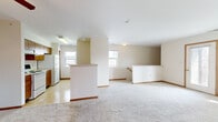 Located at 4791 Hickory Creek Dr in Richton Park, Illinois, this home offers a practical and well-organized layout across its levels, connected by a carpeted staircase with a warm wood handrail. The upper level opens into a spacious living area featuring plush carpeting, neutral-toned walls, and multiple windows that allow natural light to fill the space. A central half-wall partition separates the living area from the kitchen zone, adding subtle architectural definition without closing off the open feel.

The galley-style kitchen is equipped with warm wood cabinetry, a coil-top electric range, a full-size refrigerator, and a double-basin sink, all set on light vinyl tile flooring. A window at the end of the kitchen brings in additional natural light.

The bedrooms are carpeted and finished with neutral walls and wood baseboards. Each room features windows overlooking the surrounding neighborhood, offering views of the residential streetscape. Closet storage is available, including a reach-in closet with overhead shelving and a wood-panel door.

The bathroom includes a shower-tub combination, a toilet, a single-basin vanity with wood cabinetry, a wall-mounted mirror cabinet, and tile flooring. Throughout the home, consistent use of warm wood trim and soft neutral tones creates a cohesive and understated interior aesthetic.
