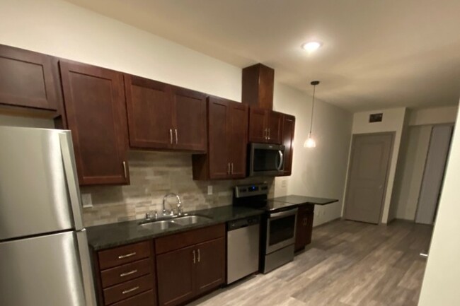 Lots of cabinet storage, tiled backsplash - The Gryff Apartments