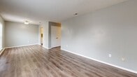 This single-floor unit in the Lexington neighborhood of Memphis, TN, offers a practical and efficiently organized layout accommodating three bedrooms and two bathrooms. The interior is finished with a consistent neutral gray color palette throughout, contributing to a clean, cohesive aesthetic.

The living area features wood-look hard flooring and receives natural light through a front-facing window alongside the entry door. A closet with double panel doors provides convenient storage directly off this main space. The galley-style kitchen is lined with white cabinetry above and below the countertops, a stainless steel double sink, and includes a full-size refrigerator and range.

The three bedrooms are carpeted and share the same neutral gray wall tones. Each room includes closet access, and several feature windows with blinds that allow natural light. The primary bedroom includes a dedicated closet and connects to the hallway.

Both bathrooms are equipped with tub-shower combinations featuring white tile surrounds, and one includes a louvered closet door for additional storage. Wood-look flooring extends into the bathrooms, maintaining consistency with the rest of the unit. A central hallway connects the bedrooms and bathrooms, organizing the private areas efficiently.