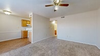 Located at 1719 N Main St in McPherson, Kansas, this single-floor unit offers a practical and well-organized layout with two bedrooms, two bathrooms, and two closets. The living area welcomes you with neutral-toned walls, plush carpeting, and a ceiling fan with light fixture, creating a comfortable and airy atmosphere. Natural light filters in through windows fitted with blinds, adding warmth to the space. The galley-style kitchen features warm honey-toned wood cabinetry, light countertops, wood-look vinyl flooring, and white appliances including a range, refrigerator, and dishwasher, providing ample functionality for everyday cooking. Both bathrooms are finished consistently, each equipped with a full tub-shower combination, a wooden vanity with a single sink, and wood-look vinyl flooring, maintaining a clean and cohesive aesthetic. The primary bedroom is generously proportioned, complete with a ceiling fan, carpeted floors, and access to a closet. The second bedroom is equally well-appointed with soft carpeting, a ceiling fan, a window for natural light, and its own closet access. Throughout the unit, the design is straightforward and neutral, offering a move-in ready canvas well-suited for a variety of living arrangements.