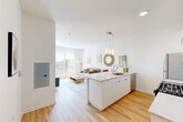 Located at 4800 157th St in Oak Forest, Illinois, this well-designed one-bedroom, one-bathroom residence offers a thoughtful layout with modern finishes throughout. Light hardwood flooring flows seamlessly across the entire unit, creating a warm, cohesive aesthetic from entry to bedroom.

The open-concept living area is anchored by a bright, sunlit living room featuring a large window with vertical blinds that invite generous natural light. The kitchen is a standout, boasting sleek white cabinetry, a spacious island with bar seating, white quartz countertops, pendant lighting, and stainless steel appliances including a gas range, microwave, refrigerator, and dishwasher. The island doubles as a dining area, making the space both functional and social.

A clean, bright hallway connects the main living spaces to the private bedroom, which features a dedicated closet, a window overlooking the outdoors, and ample room for comfortable furnishings. The full bathroom is finished with a walk-in glass-door shower stall and hardwood-style flooring, maintaining the unit's consistent modern style.

Two closets provide practical storage, and the overall design emphasizes clean lines, a neutral white color palette, and efficient use of space — making this residence a polished and functional home in Oak Forest.