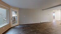 Located at 775 Cascade St in Oregon City, Oregon, this 2-bedroom, 2-bathroom residence offers a well-designed single-floor layout with a thoughtful mix of comfort and style. The open combined living and dining area serves as the heart of the home, featuring rich dark hardwood-style flooring, neutral gray walls, exposed beam detailing along the ceiling, a cozy fireplace, and a baseboard heating system. A sliding glass door leads to a private balcony, bringing in natural light and outdoor views. The kitchen is appointed with crisp white cabinetry, brushed nickel hardware, and striking marble-look quartz countertops, complemented by a pantry for added storage. Both bedrooms are carpeted and offer a calm, neutral palette, with mirrored sliding closet doors that enhance the sense of space. The primary bedroom includes its own closet and thermostat control. Each bathroom is clean and functional — one features a full tub/shower combo with a curtain rod and a vanity with white cabinetry, while the other offers a similarly bright and efficient layout with wood-look tile flooring. Additional conveniences include a dedicated laundry area, multiple closets throughout, and a welcoming entrance that sets the tone for the rest of the home.