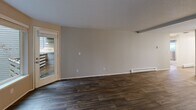 Located at 775 Cascade St in Oregon City, Oregon, this 2-bedroom, 2-bathroom residence offers a well-designed single-floor layout with a thoughtful mix of comfort and style. The open combined living and dining area serves as the heart of the home, featuring rich dark hardwood-style flooring, neutral gray walls, exposed beam detailing along the ceiling, a cozy fireplace, and a baseboard heating system. A sliding glass door leads to a private balcony, bringing in natural light and outdoor views. The kitchen is appointed with crisp white cabinetry, brushed nickel hardware, and striking marble-look quartz countertops, complemented by a pantry for added storage. Both bedrooms are carpeted and offer a calm, neutral palette, with mirrored sliding closet doors that enhance the sense of space. The primary bedroom includes its own closet and thermostat control. Each bathroom is clean and functional — one features a full tub/shower combo with a curtain rod and a vanity with white cabinetry, while the other offers a similarly bright and efficient layout with wood-look tile flooring. Additional conveniences include a dedicated laundry area, multiple closets throughout, and a welcoming entrance that sets the tone for the rest of the home.
