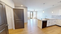 Located at 2139 Topside Rd in Alcoa, Tennessee, this well-appointed one-bedroom, one-bathroom single-floor home offers a thoughtfully designed open-concept layout. Light hardwood flooring runs throughout, lending warmth and continuity across every room.

The kitchen is a standout feature, showcasing granite countertops, white shaker-style cabinetry, a tile backsplash, and black appliances including a refrigerator, range, and built-in microwave. A peninsula with a stainless steel sink provides additional prep space and serves as a natural transition into the living areas.

Two distinct living spaces offer flexibility for dining and lounging. The main living area is bright and airy, benefiting from large windows and a glass-panel exterior door that allows natural light to flood in while providing access to an outdoor area. Ceiling fans are featured in both living spaces.

The primary bedroom is a comfortable, well-sized retreat with a large window fitted with blinds and direct access to a walk-in closet outfitted with wire shelving systems for organized storage. The bathroom includes a granite-topped vanity with white cabinetry and a full tub/shower combo. The entry foyer features a full-light glass door, creating a welcoming first impression with views to the exterior.