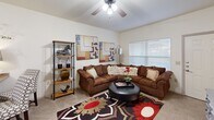 Located at 8305 Counts Massie Rd in North Little Rock, Arkansas, this one-bedroom, one-bathroom unit offers a thoughtfully designed open-concept layout that maximizes every inch of its compact footprint. The living area is warm and inviting, featuring vaulted ceilings, ceiling fans, and plush carpeting. Large windows allow natural light to fill the space, creating a bright and comfortable atmosphere throughout.

The kitchen flows seamlessly from the living area and is outfitted with rich, dark cherry wood cabinetry, granite-style countertops, and a full suite of black appliances, including a refrigerator, range, built-in microwave, and dishwasher. Wood-style flooring in the kitchen adds a clean, contemporary contrast to the cabinetry. A convenient breakfast bar provides additional seating and serves as a natural divider between the kitchen and living space.

The generously sized bedroom features soft carpeting, a ceiling fan with light fixture, and a window that invites natural light. A dedicated closet provides ample storage. The adjacent bathroom is finished with dark wood cabinetry, wood-style flooring, and a full tub-shower combination enclosed by sliding glass doors. The overall design balances functionality and comfort, making this a well-rounded living space.