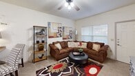 Located at 8305 Counts Massie Rd in North Little Rock, Arkansas, this one-bedroom, one-bathroom unit offers a thoughtfully designed open-concept layout that maximizes every inch of its compact footprint. The living area is warm and inviting, featuring vaulted ceilings, ceiling fans, and plush carpeting. Large windows allow natural light to fill the space, creating a bright and comfortable atmosphere throughout.

The kitchen flows seamlessly from the living area and is outfitted with rich, dark cherry wood cabinetry, granite-style countertops, and a full suite of black appliances, including a refrigerator, range, built-in microwave, and dishwasher. Wood-style flooring in the kitchen adds a clean, contemporary contrast to the cabinetry. A convenient breakfast bar provides additional seating and serves as a natural divider between the kitchen and living space.

The generously sized bedroom features soft carpeting, a ceiling fan with light fixture, and a window that invites natural light. A dedicated closet provides ample storage. The adjacent bathroom is finished with dark wood cabinetry, wood-style flooring, and a full tub-shower combination enclosed by sliding glass doors. The overall design balances functionality and comfort, making this a well-rounded living space.