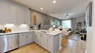 Located on E Camelback Road in Phoenix, AZ, this well-appointed one-bedroom, one-bathroom residence offers a thoughtfully designed open-concept layout. Light hardwood-style flooring flows throughout the main living areas, anchoring a bright and cohesive aesthetic.

The kitchen is a standout feature, showcasing gray shaker-style cabinetry with under-cabinet lighting, white quartz countertops, and a full suite of stainless steel appliances including a gas range, built-in microwave, and dishwasher. A peninsula with a double sink connects the kitchen seamlessly to the living area, making it ideal for everyday living and entertaining.

The living room is generously proportioned, featuring a ceiling fan, a large window that invites natural light, and neutral-toned walls that complement the warm flooring. The bedroom offers plush carpeting, a bold accent wall, a ceiling fan, and a dedicated closet, creating a comfortable and private retreat.

The bathroom includes a full soaking tub with a tiled surround and hardwood-style flooring that ties the room together. A dedicated in-unit laundry closet with a stacked washer and dryer adds exceptional convenience. This residence combines functional design with modern finishes throughout.