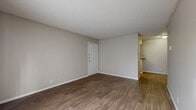 Located at 6313 Evers Rd in Leon Valley, TX, this one-bedroom, one-bathroom unit offers a practical and efficient single-floor layout. The living room is bright and open, featuring warm wood-look flooring, neutral gray walls, and a textured ceiling that carries throughout the space. A sliding glass door with vertical blinds allows natural light to fill the room, creating an inviting atmosphere. The kitchen is designed for functionality, with white cabinetry, dark speckled countertops, a stainless steel double sink, and black appliances including a refrigerator, electric range, and dishwasher. Adjacent to the kitchen is a dedicated dining area, along with a pantry for additional storage. The bedroom is a comfortable size, equipped with a ceiling fan with light fixture, a window with blinds, and access to a walk-in closet featuring built-in shelving. The bathroom includes a full tub-shower combo with brushed nickel fixtures, a toilet, and a vanity with dark countertops and white cabinetry. A utility room provides added convenience. Wood-look flooring runs consistently throughout, tying the space together with a clean, cohesive look.