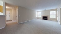 This single-floor residence in Alpharetta, Georgia offers a functional and comfortable layout with neutral warm tones throughout. The expansive living room serves as the central gathering space, featuring plush wall-to-wall carpeting, a textured ceiling, and a brick-surround fireplace flanked by a window that allows natural light to filter in. The open layout connects seamlessly to the entryway and kitchen area, enhancing the overall sense of space.

The kitchen is equipped with warm oak cabinetry offering generous storage, light-toned countertops, a white appliance suite including an electric range, built-in microwave, and refrigerator, and durable wood-look flooring. A pass-through counter connects the kitchen to the main living area, making it well-suited for everyday use.

Bedrooms are carpeted and well-proportioned, with one featuring dual windows, a ceiling fan with light fixture, and access to a walk-in closet. The bathrooms are finished with stone-look tile flooring, rich wood-toned vanity cabinetry, extended countertops, and well-lit vanity mirrors. A central hallway provides easy access to all areas of the unit, contributing to a practical and cohesive floor plan.