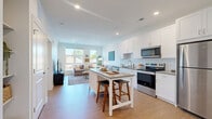 Located at 1350 W Fifth Ave in Columbus, Ohio, this well-designed one-bedroom, one-bathroom residence offers a thoughtful layout across a single floor. The open-concept kitchen and living area serves as the heart of the home, featuring crisp white shaker cabinetry, a classic subway tile backsplash, stainless steel appliances, and a central island with seating — ideal for both everyday meals and casual entertaining. Light wood-tone flooring flows seamlessly throughout the main living area, complementing the clean, contemporary aesthetic.

The living room is bright and airy, benefiting from large windows that frame outdoor views of the surrounding neighborhood and flood the space with natural light. A private balcony extends the living area outdoors. A pantry and in-unit laundry add practical convenience.

The bedroom is a calm, comfortable retreat with large windows overlooking lush tree canopy, providing a peaceful, nature-connected atmosphere. A dedicated closet offers organized storage. The full bathroom is finished with white cabinetry, a single-sink vanity, and a walk-in shower with clean-lined surround. Throughout the residence, a neutral, light-filled palette creates a cohesive and inviting ambiance suited to modern urban living.