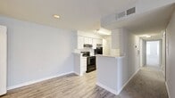Located at 1104 Baywood Cir in Morrow, Georgia, this single-story home offers five bedrooms and two full bathrooms within a efficiently arranged floor plan. The open-concept kitchen and living area serves as the heart of the home, featuring light wood-style flooring, white cabinetry, speckled countertops, and black appliances including a range and refrigerator. A peninsula counter provides additional workspace and separates the kitchen from the living area, which benefits from recessed lighting and a textured ceiling.

The bedrooms are carpeted throughout and finished in neutral tones, with several rooms featuring ceiling fans with light fixtures and windows that allow natural light. The primary bedroom includes closet access, while additional closet space is provided across the home, including a walk-in closet with wire shelving systems. Bedrooms vary in size, offering flexible use as sleeping quarters, a home office, or additional living space.

The bathrooms are clean and functional, featuring light wood-style flooring, a tub-shower combination, toilet, and a vanity with a speckled countertop. The overall aesthetic of the home is consistent, with white trim, neutral gray walls, and a bright, well-maintained interior throughout.