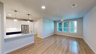 Located in Austin's vibrant 78722 zip code, this well-appointed 2-bedroom, 3-bathroom single-story home offers a thoughtfully designed open-concept layout with modern finishes throughout. Light hardwood flooring flows seamlessly across the entire living area, complemented by neutral wall tones that create a bright and welcoming atmosphere.

The kitchen is a standout feature, showcasing striking two-tone cabinetry with bold navy lower cabinets and crisp white uppers, paired with a herringbone tile backsplash and stainless steel appliances including a range, microwave, dishwasher, and refrigerator. A central island with pendant lighting and a sink adds both functionality and style. The kitchen opens directly to the spacious living area, which is bathed in natural light from multiple windows fitted with blinds and is accented by a ceiling fan.

The primary bedroom is generously sized, featuring large windows, a ceiling fan, and access to a well-appointed en-suite bathroom with a dual-sink vanity, backlit mirrors, matte black fixtures, and subway tile detailing, along with a walk-in closet. The secondary bedroom also benefits from natural light and hardwood floors. Additional bathrooms feature white subway tile tub surrounds and matte black hardware. Two closets provide ample storage throughout the home.