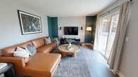 Located at 25834 110th Ave SE in Kent, Washington, this single-floor, 2-bedroom, 1-bathroom home offers a thoughtfully designed layout that makes efficient use of its space. The living room serves as a welcoming focal point, featuring light wood-style flooring, a bold teal accent wall, a textured ceiling, and a sliding glass door that invites natural light and outdoor views. The galley-style kitchen is outfitted with white cabinetry, dark countertops, stainless steel appliances including a refrigerator and dishwasher, and wood-style flooring that ties the space together cleanly. A central hallway connects the rooms and provides access to an in-unit stacked washer and dryer — a practical and convenient amenity. The primary bedroom is a comfortable retreat featuring carpet flooring, a built-in closet with sliding doors, and windows that allow in natural light. The second bedroom mirrors the living room's teal accent wall, adding a vibrant design touch, and also includes a closet and natural light. The shared bathroom features wood-style flooring and clean, neutral finishes. Throughout the home, a consistent palette of soft grays and whites creates a calm, cohesive ambiance.
