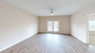 Located at 2250 Hard Scrabble Rd in Columbia, SC, this single-story, 3-bedroom, 2-bathroom home delivers a clean, modern aesthetic with thoughtful finishes throughout. The open-concept living area features light wood-look luxury vinyl flooring, a ceiling fan, and a set of French doors that invite natural light and provide outdoor access, creating an airy and welcoming atmosphere.

The kitchen is a standout, showcasing white shaker-style cabinetry, stainless steel appliances, and a granite-topped island with an integrated sink and stylish pendant lighting — an ideal space for cooking and entertaining alike.

Each bedroom is carpeted for comfort, with ceiling fans and natural light from windows with blinds. The spacious primary bedroom includes its own walk-in closet outfitted with wire shelving. A second closet offers additional storage with built-in wire rack organization.

Both bathrooms are finished with granite countertops, white cabinetry with brushed nickel hardware, and wood-look vinyl flooring. One bathroom features a tub-shower combo, while the other includes a walk-in shower. The neutral warm-toned walls throughout the home lend a cohesive, move-in-ready feel that suits a variety of décor styles.