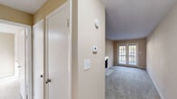 Located at 14A Merry Ln in Greenville, NC, this 2-bedroom, 1-bathroom single-story home offers a practical and comfortable layout. The living area features neutral beige walls, plush carpeting, and a fireplace, with French doors that open to an outdoor deck, flooding the space with natural light and providing easy outdoor access. A second living area adds flexibility for dining or additional seating arrangements.

The kitchen is well-equipped with rich wood cabinetry, stainless steel appliances including a refrigerator, range, and dishwasher, light countertops, and durable wood-look flooring. A window above the double-basin sink allows for natural light.

Both bedrooms are carpeted with neutral tones and include closets with built-in shelving and hanging rods. The primary bedroom offers a comfortable footprint with a window overlooking the exterior. The full bathroom features a tub-shower combination with a curved curtain rod, wood-look flooring, and warm beige walls.

A dedicated laundry area houses a full-sized washer and dryer set with overhead shelving for added storage. Hallways connect the spaces efficiently, and a thermostat is conveniently located near the entry. This home provides a straightforward, functional living environment in a residential Greenville neighborhood.