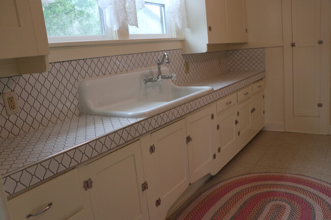 Antique farmhouse sink and hardware accentuate the custom tile ounter top - 909 8th St