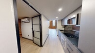 Located at 30 Laurel St in Hartford, CT, this two-story loft space masterfully combines historic industrial character with contemporary design. The main floor features soaring ceilings with striking exposed red steel trusses and warm wood planking overhead, complemented by original exposed brick walls that add texture and depth throughout. Light-toned flooring runs underfoot, and a sleek cable-railing staircase with steel stringers serves as both a functional and architectural centerpiece, leading to the upper level. A dedicated kitchen area is outfitted with flat-front gray cabinetry, dark granite countertops, a matching tile backsplash, an induction cooktop, built-in oven, and stainless steel fixtures — delivering a polished, modern culinary space. The bathroom is clean and contemporary, featuring a multi-function tower shower with tile surround, a modern toilet, dual sinks, and a mirrored medicine cabinet. The upper floor offers an intimate mezzanine-style space framed by large arched and rectangular windows that allow natural light to pour in, with the exposed brick continuing to define the aesthetic. A wall-mounted mini-split system provides climate control throughout. The result is a dynamic, loft-style space that honors its architectural heritage while offering modern comfort and functionality.
