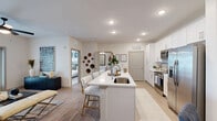 Located at 4101 William Turner Pkwy in Nashville, TN, this thoughtfully designed one-bedroom, one-bathroom residence offers a cohesive open-concept layout that maximizes every square foot. Light wood-style flooring flows throughout the main living areas, creating a warm and unified aesthetic. The living room is bright and inviting, featuring a ceiling fan, sheer curtain-framed windows, and a glass door providing direct outdoor access and natural light. The kitchen is a standout feature, showcasing crisp white cabinetry, quartz countertops, stainless steel appliances, and a generous island with bar seating — ideal for both cooking and casual dining. Recessed lighting illuminates the space effectively. The bedroom offers plush carpeting, a ceiling fan, a large window with outdoor views, and direct access to a dedicated walk-in closet, providing ample storage. The full bathroom is clean and functional, finished with white cabinetry, a quartz vanity, and a tiled shower-tub combination. Throughout the residence, a neutral color palette, panel-style doors, and consistent finishes contribute to a modern, move-in-ready atmosphere. This well-rounded home delivers practical comfort in a polished Nashville setting.