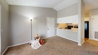 Located at 374 Elston Rd in Lafayette, Indiana, this one-bedroom, one-bathroom unit offers a practical and comfortable single-floor layout. The living area features warm neutral-toned carpet, vaulted ceilings that lend a sense of openness, and a sliding glass door that leads to a private wooden deck — a standout feature that extends the living space outdoors. The kitchen is efficiently designed with wood-look flooring, white cabinetry, light countertops, a double sink, and black appliances including a range and full-size refrigerator. A pass-through counter connects the kitchen to the living area, enhancing the open feel of the shared space. The bedroom is generously proportioned, carpeted for comfort, and features a window that allows in natural light, along with a closet offering built-in shelving for ample storage. The bathroom is clean and well-appointed, complete with a vanity, a full tub-shower combination, and wood-look flooring that ties the space together. Throughout the unit, soft gray walls and white trim create a consistent, neutral palette that is both modern and easy to personalize. This well-organized unit is an ideal choice for those seeking a low-maintenance, efficiently designed living space in Lafayette.