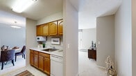Located at 1417 Valley Lake Dr in Schaumburg, IL, this one-bedroom, one-bathroom residence offers a well-organized, single-floor layout that makes efficient use of its space. The kitchen features warm oak cabinetry with ample upper and lower storage, white countertops, a stainless steel sink, and includes a dishwasher — all finished with easy-care tile flooring. Adjacent to the kitchen, the dedicated dining area provides a defined space for meals, with neutral walls and carpeted flooring that continues throughout the living spaces. The bedroom is a comfortable retreat, featuring plush carpet, a natural-light window with sheer curtains, and a full-panel closet offering generous storage. The bathroom includes a full tub-shower combination with clean white tile surround. Throughout the home, a neutral color palette of soft grays and warm whites creates a cohesive and calm ambiance. Textured ceilings are consistent across all rooms, contributing to the architectural character of the space. A hallway connects the rooms with ease, enhancing the functional flow of the floor plan. This well-appointed residence in Schaumburg provides a comfortable and practical living environment with all essential spaces thoughtfully arranged.