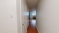 Located at 2706 Genoa Ave in Lubbock, Texas, this single-story, one-bedroom, one-bathroom home offers a practical and comfortable layout across a generously sized floor plan. The living room serves as the heart of the home, featuring rich hardwood-style flooring, a textured ceiling, a ceiling fan, and a large window fitted with blinds that allows natural light to fill the space, creating a warm and inviting atmosphere.

The kitchen is notably spacious, laid out in a galley-style configuration with warm honey-toned wood cabinetry lining both sides. It is equipped with a range, dishwasher, refrigerator, and a double sink, along with a window that brings in additional natural light. A peninsula area adds functional counter space, and hardwood-style flooring continues throughout, lending a cohesive feel to the space.

The bedroom is a comfortable retreat, finished with plush carpeting that adds warmth underfoot. A large window with blinds provides natural light, and the room offers enough space to accommodate a queen-sized bed with room to spare.

The bathroom is clean and straightforward, featuring a full tub-shower combination, a vanity with wood cabinetry, and hardwood-style flooring. A hallway connects the rooms efficiently, completing this well-organized and functional home.