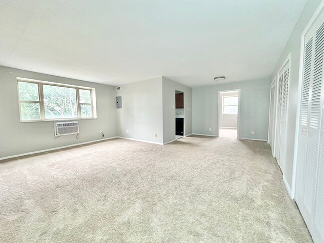 Carpeted Living Room - Waldorf Park Apartments