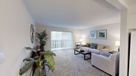 This 2-bedroom, 1-bathroom residence in New Britain, Connecticut offers a thoughtfully designed single-floor layout that maximizes comfort and functionality. The carpeted living room is a welcoming centerpiece, featuring large sliding glass doors with vertical blinds that flood the space with natural light and provide access to an outdoor balcony view. The area flows seamlessly into a dedicated dining space, illuminated by a classic chandelier, making it ideal for everyday living and entertaining. The kitchen is well-equipped with crisp white shaker cabinetry, dark granite-style countertops, tile flooring, and a full suite of appliances including a gas range, dishwasher, and over-the-range microwave. Both bedrooms are carpeted and offer a calm, neutral ambiance. The spacious primary bedroom comfortably accommodates large furniture, while the second bedroom benefits from a bright window with outdoor views. Each bedroom is served by its own closet. The full bathroom features tile flooring, a white vanity with a mirrored medicine cabinet, and a shower/tub combination. Throughout the residence, neutral tones and clean finishes create a cohesive and move-in-ready atmosphere.