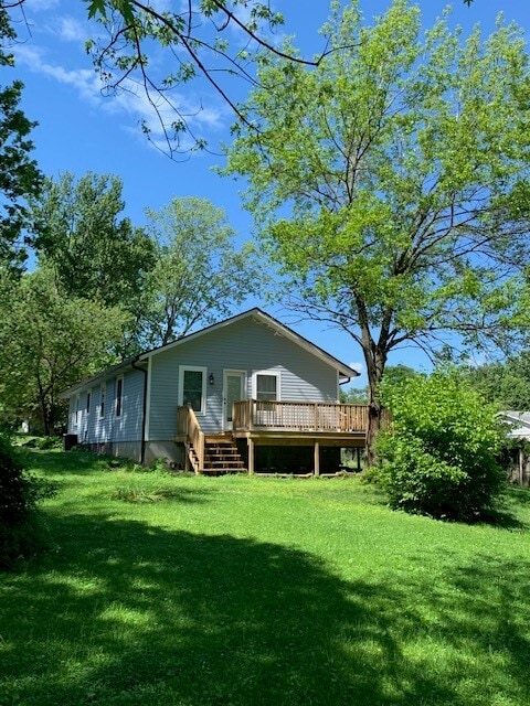 Back view, door enters master bedroom, spacious yard with fire pit and room for gardening - 607 W Duncan Dr