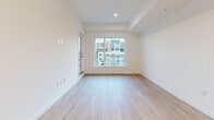 Located at 4118 Cambie Street in Vancouver, BC, this thoughtfully designed 2-bedroom, 1-bathroom unit offers a clean, modern aesthetic throughout. Light-toned hardwood flooring runs continuously across all rooms, creating a cohesive and airy feel. The open-concept kitchen and living area forms the heart of the unit, with the kitchen showcasing warm wood cabinetry, white countertops, a clean tile backsplash, and a full suite of stainless steel appliances including a refrigerator, range, and dishwasher. The living area is bright and open, with a large sliding window that frames views of the surrounding Vancouver neighbourhood. A connecting hallway leads to two well-proportioned bedrooms, each featuring large windows that bring in natural light and overlook the streetscape. The primary bedroom offers a comfortable retreat with clean white walls and generous natural light. A versatile den provides additional flexible space, suitable as a home office or storage area. The bathroom is finished with light tile flooring, a soaker tub with overhead shower, wood-toned cabinetry, and a white undermount sink, reflecting the same contemporary sensibility found throughout the unit. Recessed lighting and a neutral colour palette complete the modern, move-in-ready character of this Vancouver home.