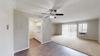 Located at 9440 Clover Avenue in Fountain Valley, California, this well-appointed one-bedroom, one-bathroom unit offers a comfortable and functional single-floor layout. The open-concept living and dining area is bright and inviting, featuring warm neutral tones, crown molding, a ceiling fan with light fixture, and a combination of durable wood-style flooring and plush carpeting. Vertical blinds frame a sliding glass door that fills the space with natural light and provides outdoor access and views of the surrounding greenery.

The kitchen is efficiently laid out with white cabinetry, speckled quartz-style countertops, a gas range, built-in microwave, and a sink positioned to overlook the living area, making the space feel connected and open.

The bedroom is a comfortable retreat featuring plush carpet, a ceiling fan, crown molding, and a large sliding-door closet offering ample storage. A window with vertical blinds allows natural light to filter in while maintaining privacy.

The bathroom is clean and functional, with wood-style flooring, a single-sink vanity topped with speckled countertops, a large mirror, and a full tub-shower combination. Throughout the unit, a consistent neutral color palette and thoughtful finishes create a cohesive and livable atmosphere.