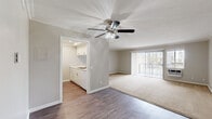 Located at 9440 Clover Avenue in Fountain Valley, California, this well-appointed one-bedroom, one-bathroom unit offers a comfortable and functional single-floor layout. The open-concept living and dining area is bright and inviting, featuring warm neutral tones, crown molding, a ceiling fan with light fixture, and a combination of durable wood-style flooring and plush carpeting. Vertical blinds frame a sliding glass door that fills the space with natural light and provides outdoor access and views of the surrounding greenery.

The kitchen is efficiently laid out with white cabinetry, speckled quartz-style countertops, a gas range, built-in microwave, and a sink positioned to overlook the living area, making the space feel connected and open.

The bedroom is a comfortable retreat featuring plush carpet, a ceiling fan, crown molding, and a large sliding-door closet offering ample storage. A window with vertical blinds allows natural light to filter in while maintaining privacy.

The bathroom is clean and functional, with wood-style flooring, a single-sink vanity topped with speckled countertops, a large mirror, and a full tub-shower combination. Throughout the unit, a consistent neutral color palette and thoughtful finishes create a cohesive and livable atmosphere.